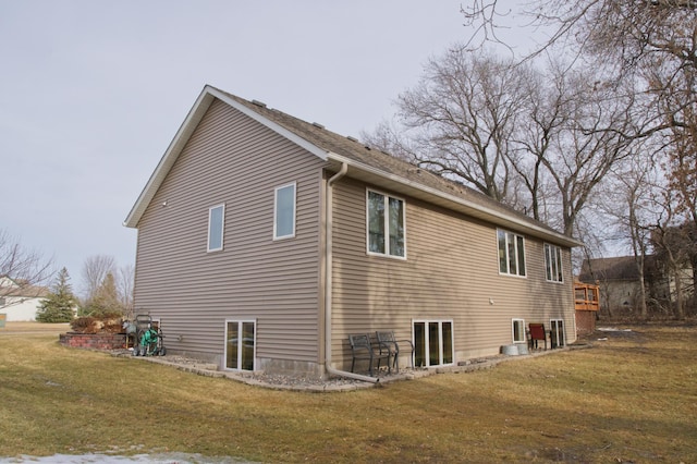 view of side of home with a yard