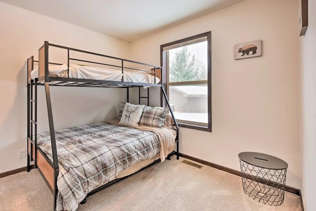 bedroom featuring visible vents, carpet floors, and baseboards