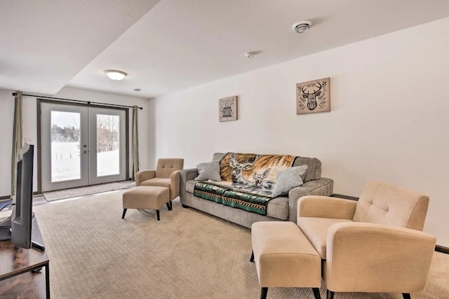 living room featuring french doors and carpet