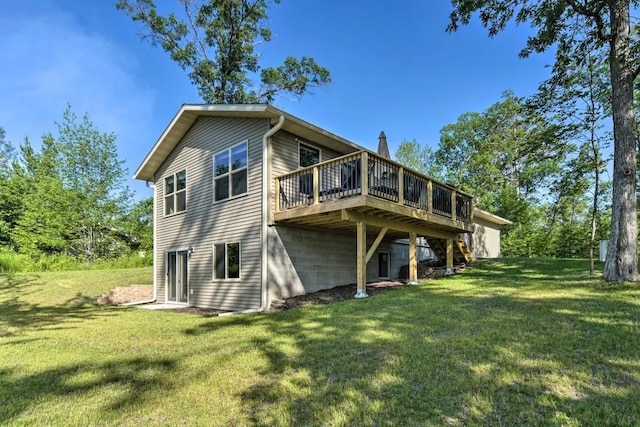 rear view of house featuring a deck, a yard, and a chimney