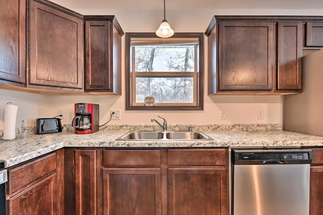 kitchen with decorative light fixtures, a sink, dark brown cabinets, and stainless steel dishwasher