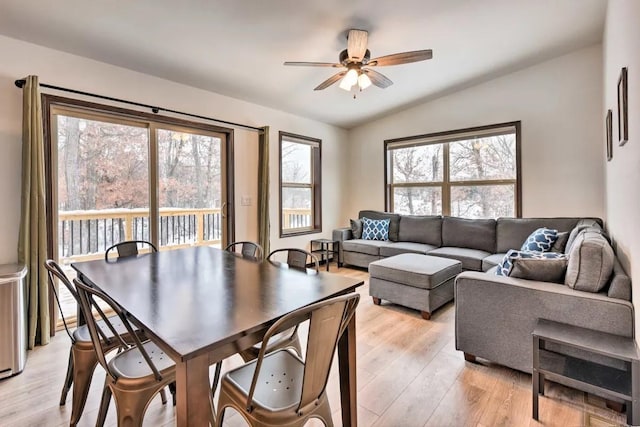 dining room featuring a wealth of natural light, light wood-style flooring, lofted ceiling, and ceiling fan