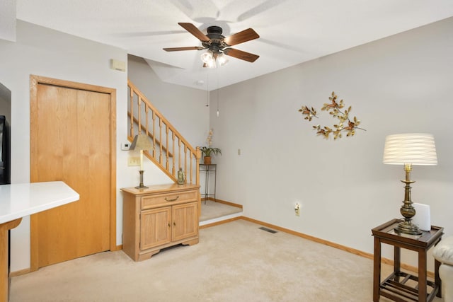 interior space with visible vents, carpet floors, baseboards, and a ceiling fan