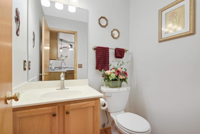 half bathroom with vanity and toilet