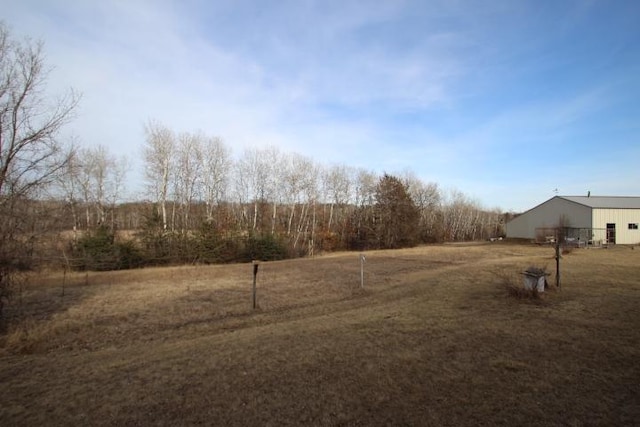 view of yard with an outbuilding and a pole building