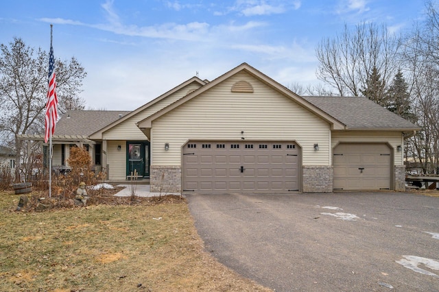 view of front of property with aphalt driveway, brick siding, roof with shingles, and an attached garage