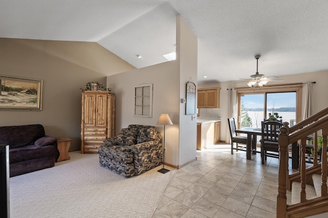 living room featuring baseboards, lofted ceiling, and ceiling fan