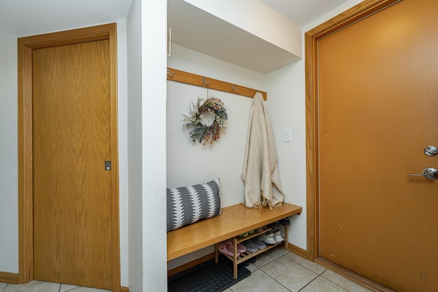 mudroom featuring baseboards and light tile patterned flooring