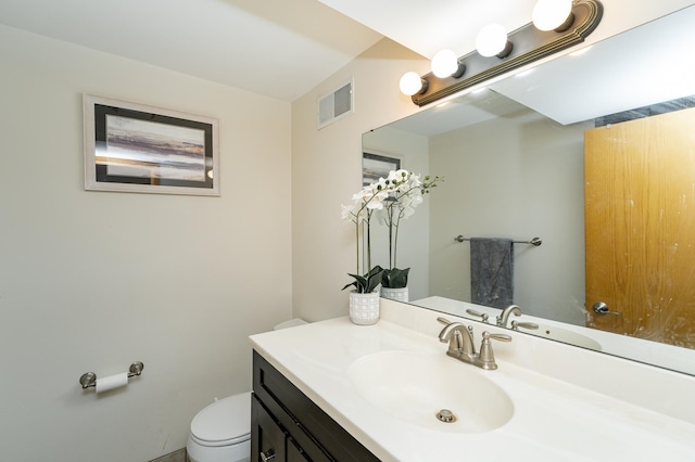 bathroom with visible vents, toilet, and vanity