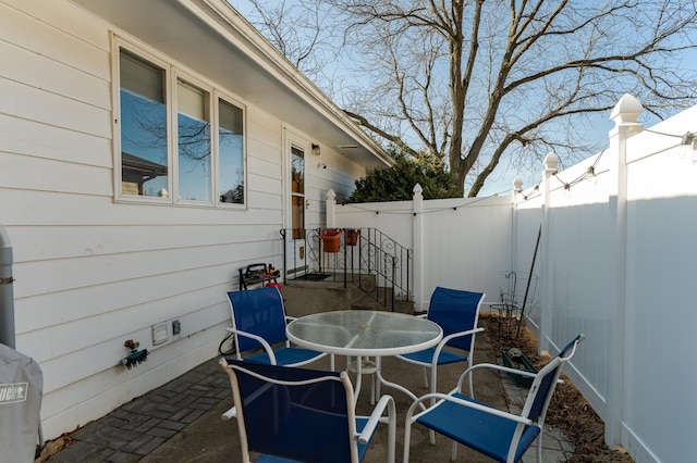 view of patio with outdoor dining space and a fenced backyard