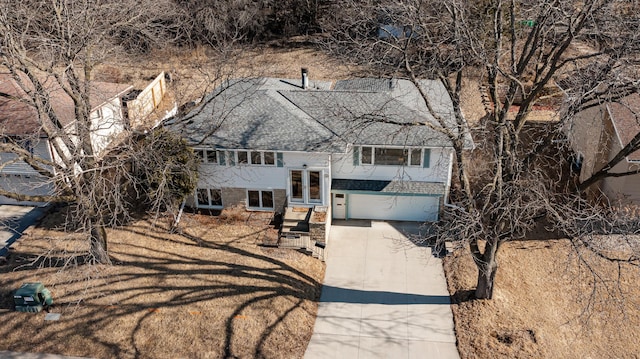 view of front facade featuring brick siding, driveway, and a shingled roof