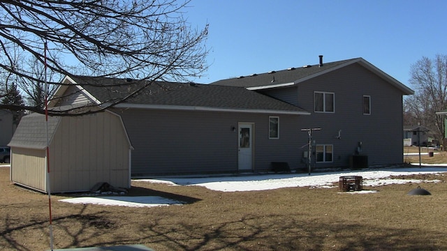 rear view of property featuring a patio, a lawn, and an outbuilding