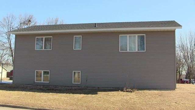 view of side of home with a yard