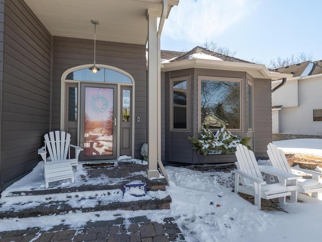 view of snow covered property entrance