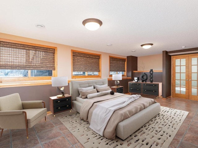 bedroom with light tile patterned floors and french doors