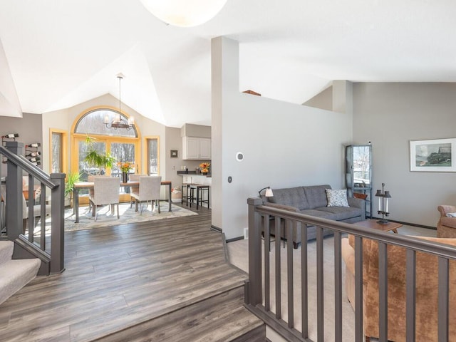 interior space featuring baseboards, dark wood-type flooring, a healthy amount of sunlight, and stairs