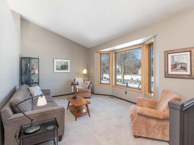 living room with vaulted ceiling, light colored carpet, baseboards, and visible vents