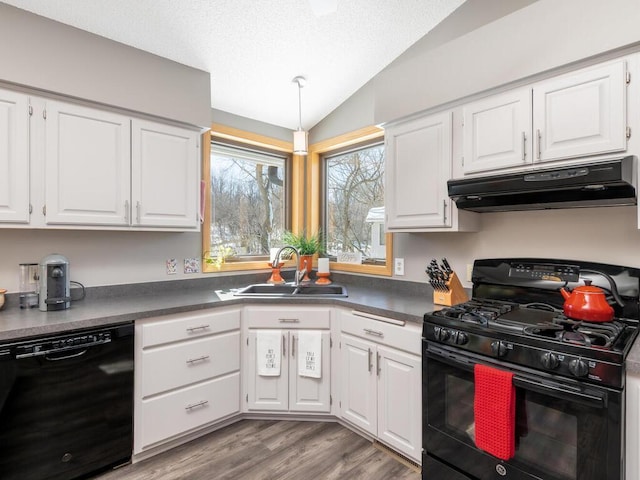 kitchen featuring black appliances, white cabinets, under cabinet range hood, and a sink