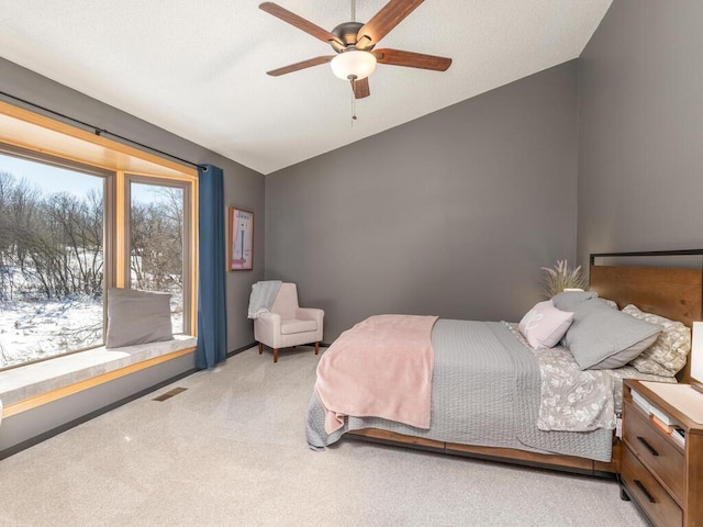 bedroom featuring vaulted ceiling, carpet, visible vents, and ceiling fan