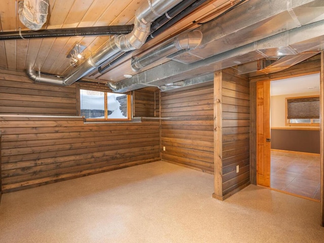 basement featuring wooden walls