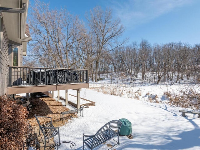 yard layered in snow with a deck