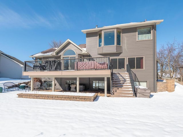 snow covered property featuring stairs