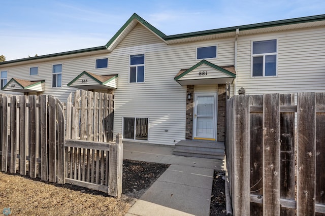 rear view of house featuring fence