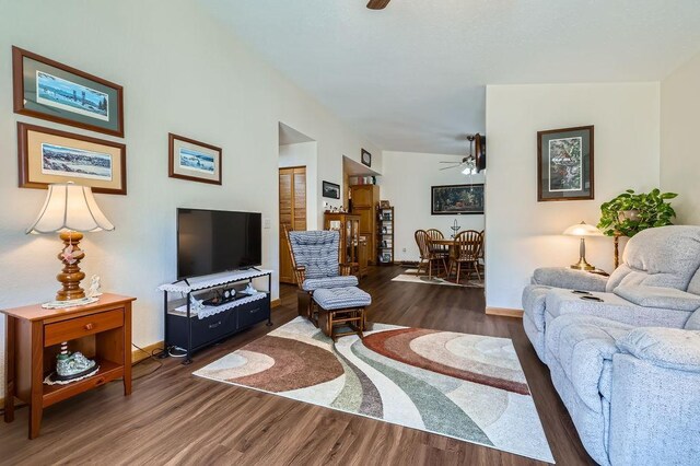 living area featuring ceiling fan, baseboards, and wood finished floors