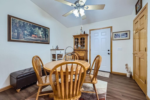 dining room featuring dark wood-style floors, a ceiling fan, and baseboards