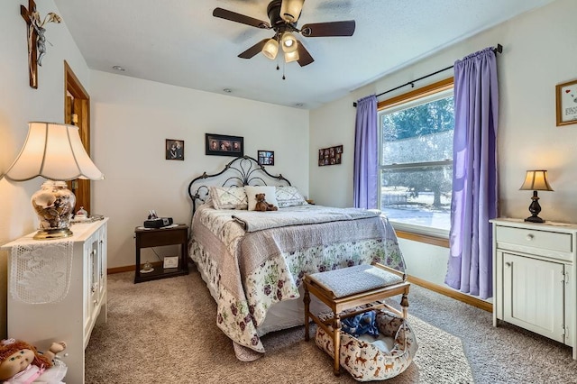 bedroom featuring baseboards, light carpet, and ceiling fan