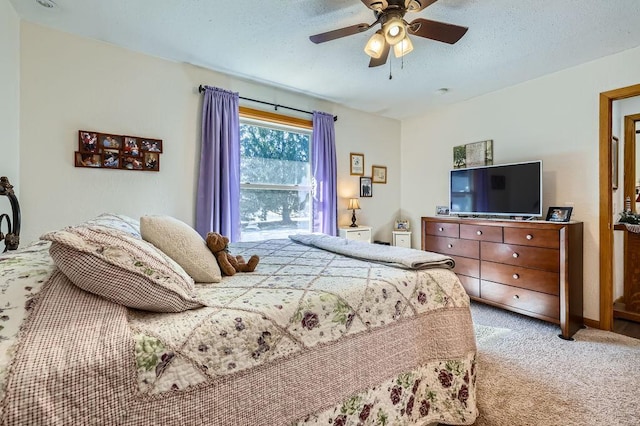 carpeted bedroom featuring a textured ceiling and a ceiling fan