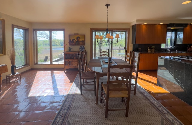 6 Crocus Ln, North Oaks, MN 55127 - tiled dining space featuring a chandelier, a sink, and baseboards