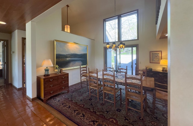 6 Crocus Ln, North Oaks, MN 55127 - dining space featuring a chandelier, a high ceiling, tile patterned flooring, and baseboards