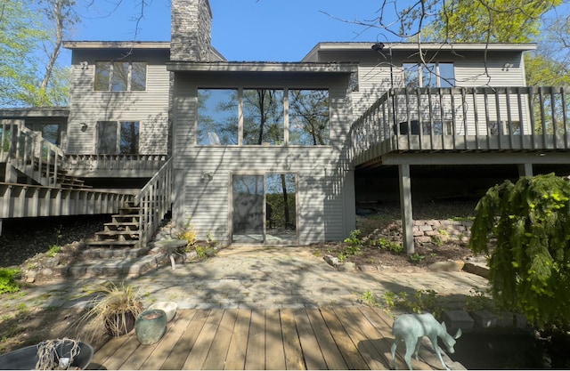 6 Crocus Ln, North Oaks, MN 55127 - back of property featuring stairway, a wooden deck, and a chimney