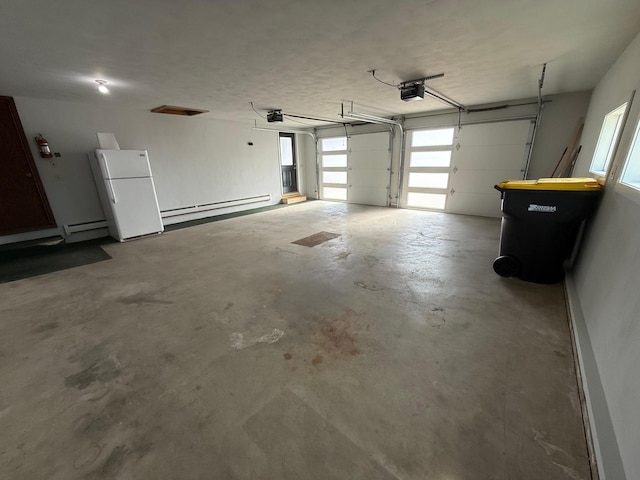 garage featuring a baseboard radiator, a garage door opener, and freestanding refrigerator