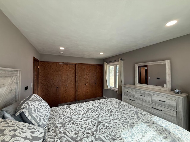 bedroom with recessed lighting and multiple closets