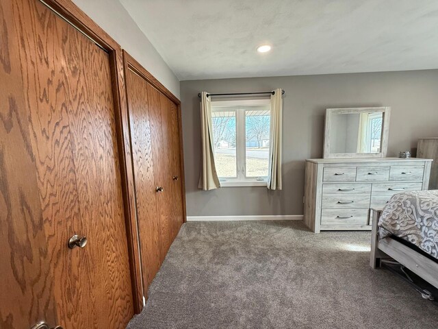 carpeted bedroom featuring baseboards