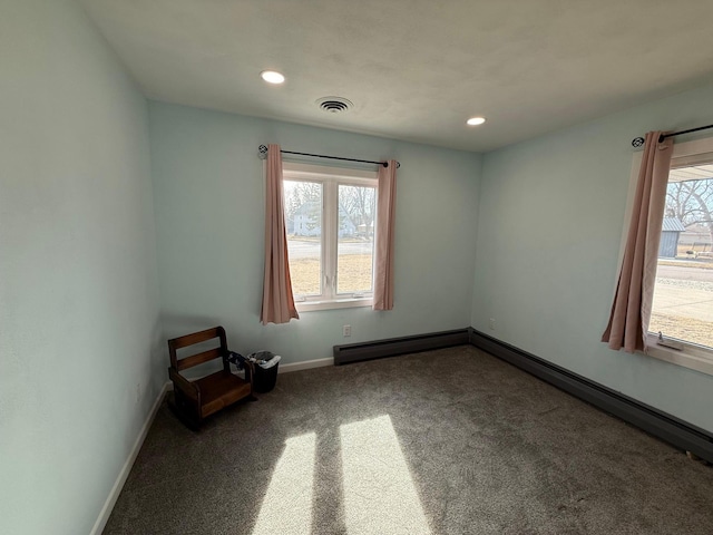 unfurnished room with a wealth of natural light, visible vents, and baseboards