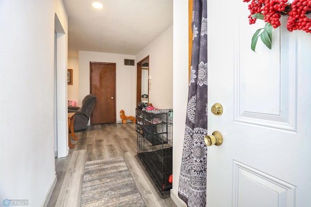 foyer featuring wood finished floors, visible vents, and baseboards