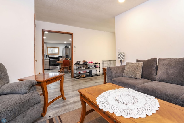 living room with recessed lighting and light wood-style flooring