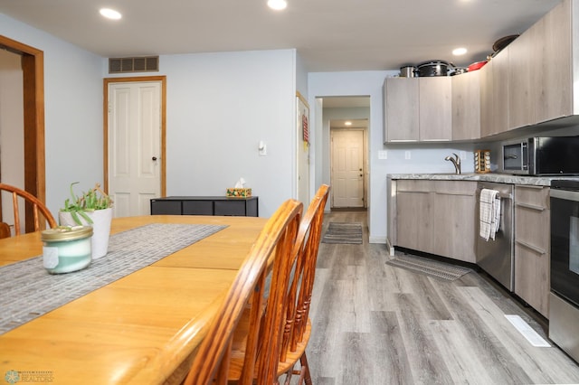 kitchen featuring visible vents, light wood finished floors, recessed lighting, stainless steel appliances, and light countertops