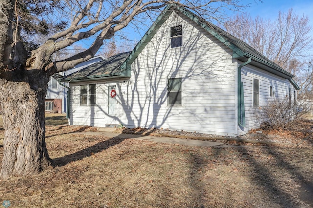 view of property exterior featuring roof with shingles