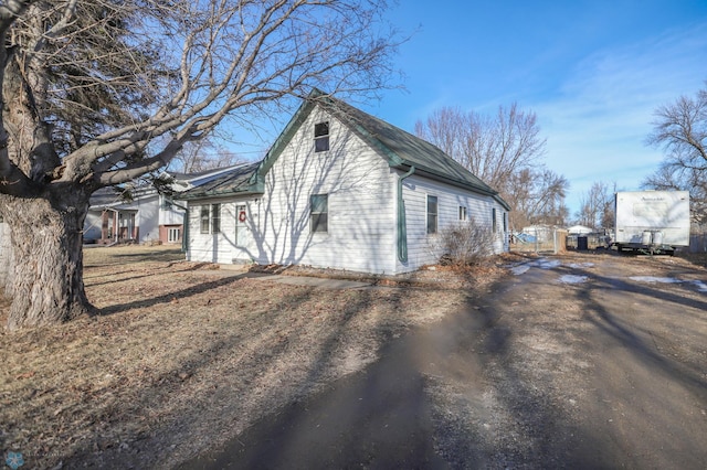 view of property exterior featuring aphalt driveway