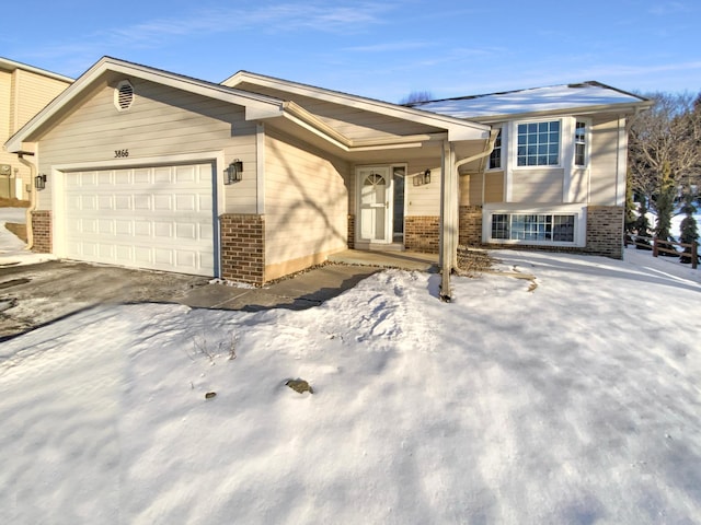 view of front of property with a garage and brick siding