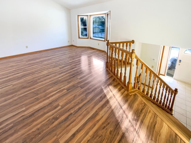 interior space with baseboards and wood finished floors