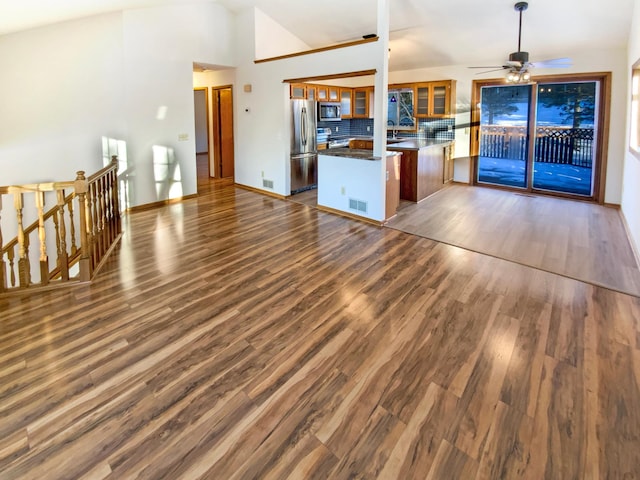 kitchen with dark wood-style floors, visible vents, a peninsula, appliances with stainless steel finishes, and dark countertops