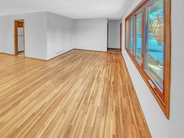 empty room with visible vents and light wood-style floors