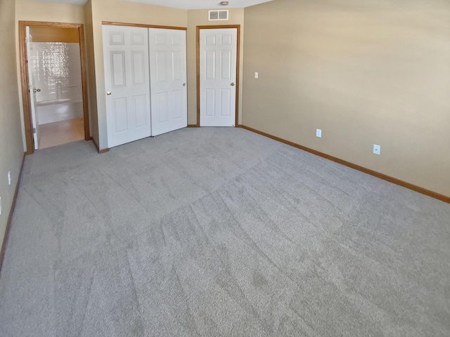 unfurnished bedroom featuring a closet, visible vents, baseboards, and carpet