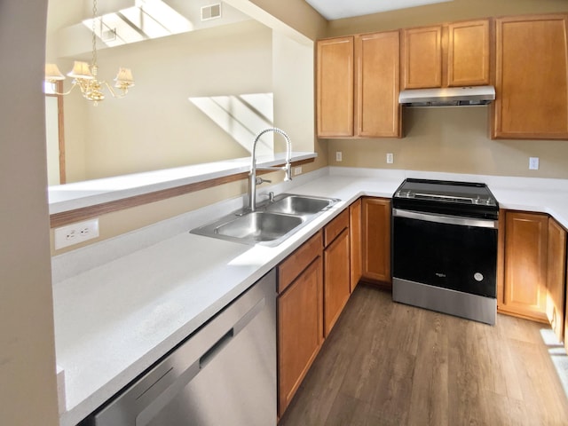 kitchen featuring visible vents, a sink, electric stove, under cabinet range hood, and stainless steel dishwasher