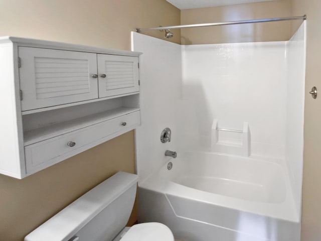 bathroom with bathtub / shower combination and toilet